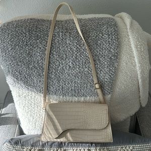 beige asymmetrical cross body or shoulder bag